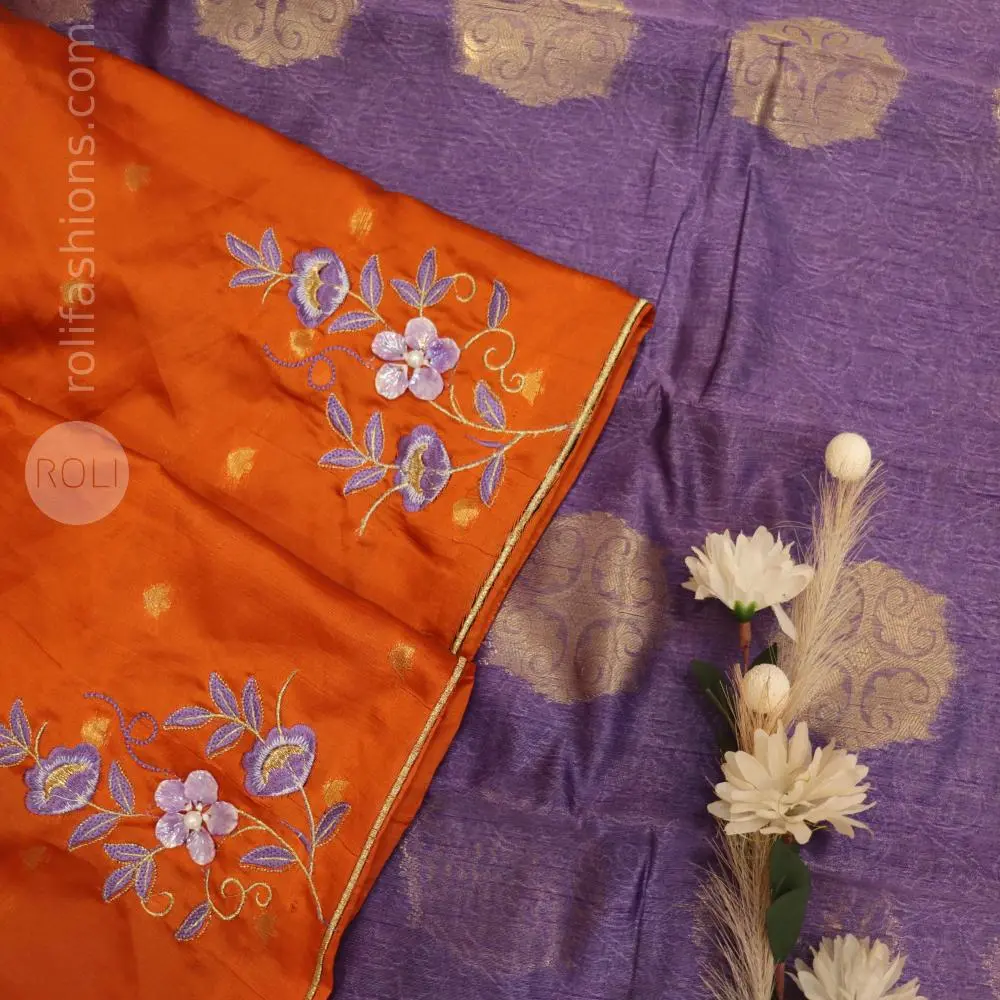 A fancy saree with shell brooch and embroidery hybrid designer blouse