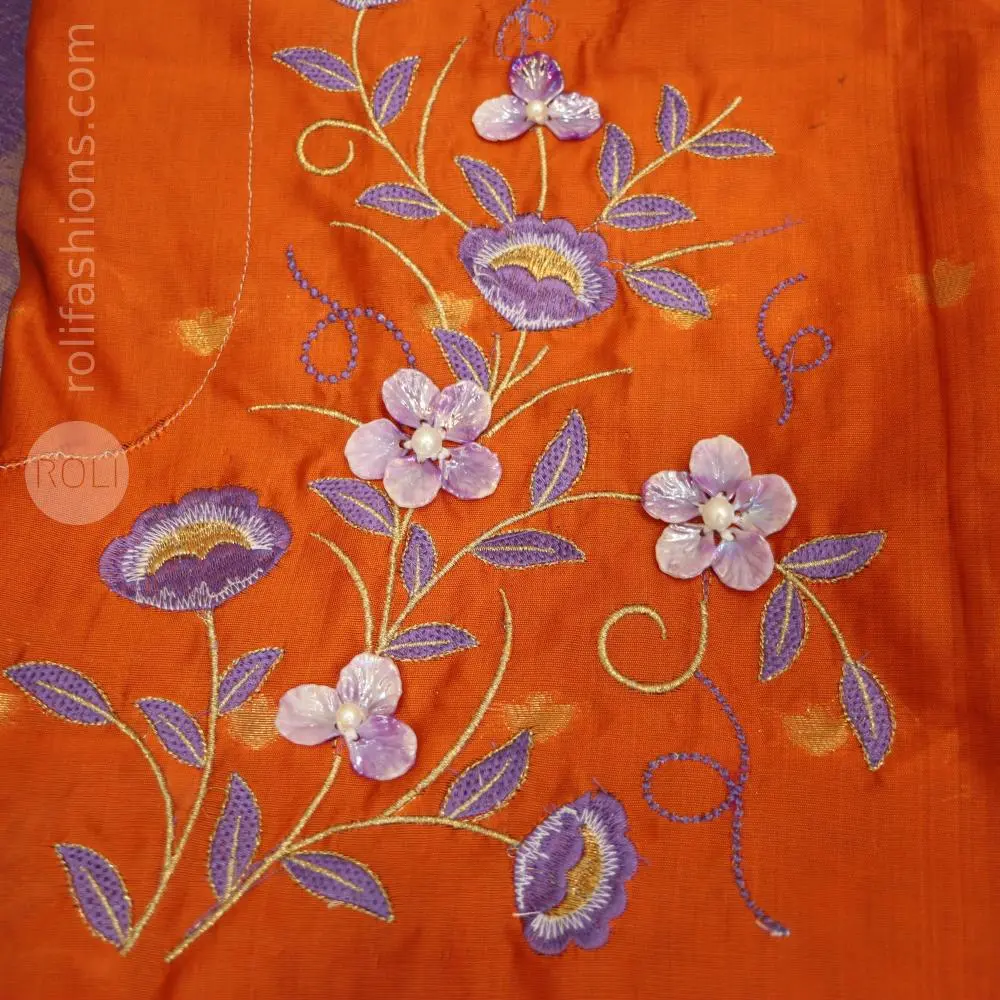 A fancy saree with shell brooch and embroidery hybrid designer blouse