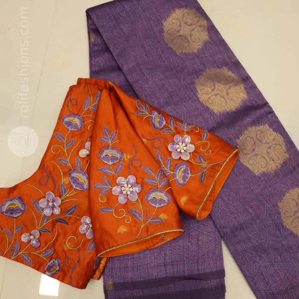 A fancy saree with shell brooch and embroidery hybrid designer blouse