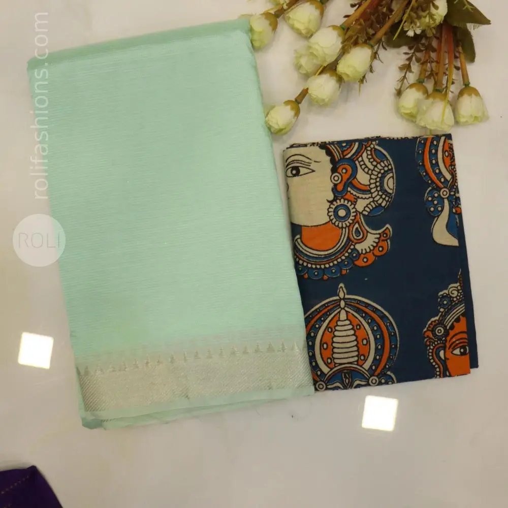 soft pastel mint green / seafoam green with a delicate silver zari border.