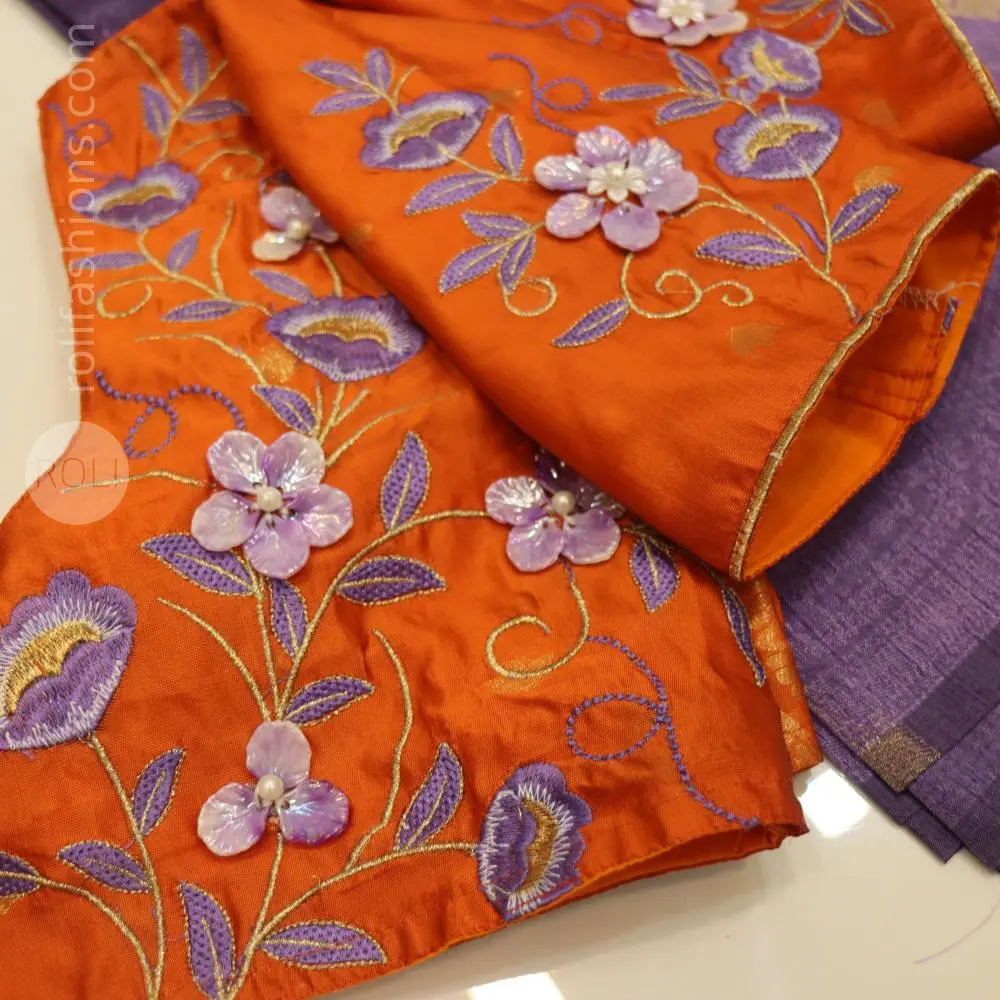 A fancy saree with shell brooch and embroidery hybrid designer blouse